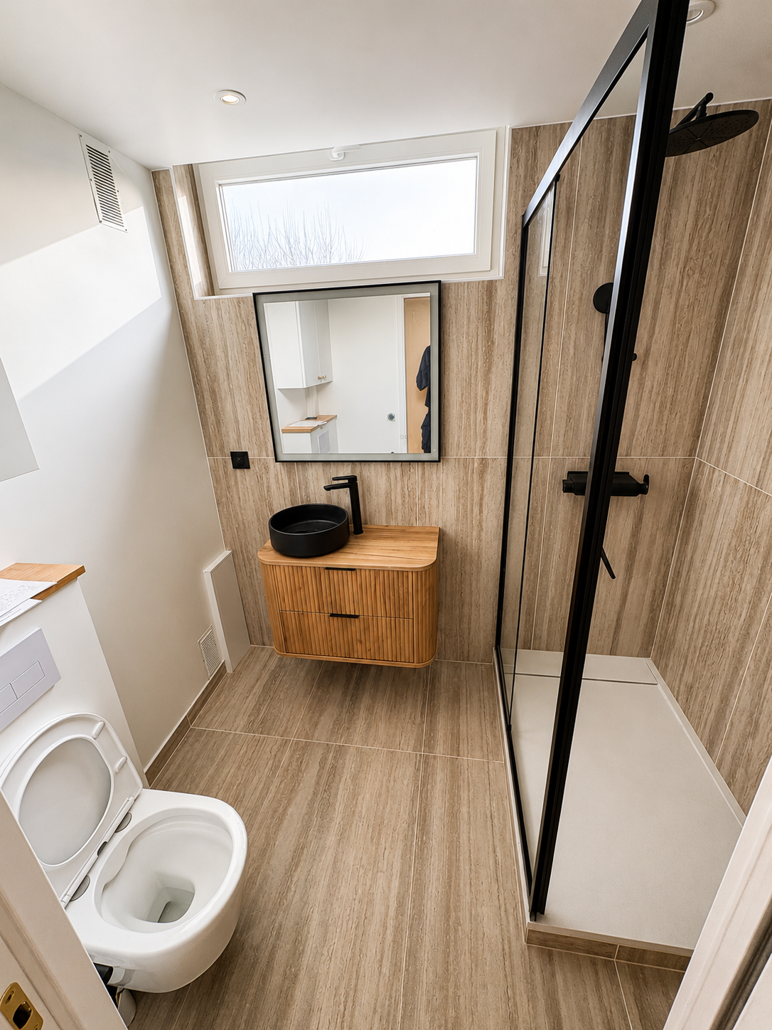 Salle de bain rénovée à Noisy-le-Roi avec meuble vasque bois et douche noire